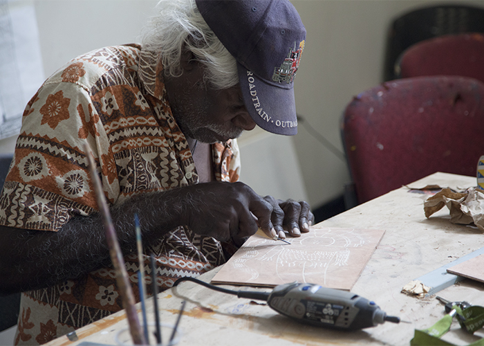 Donny Woolagoodja etching in the studio